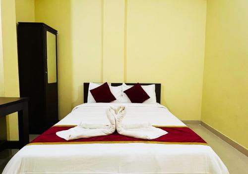 a bed with two pairs of white shoes on it at Rivera Holiday Home in Vythiri