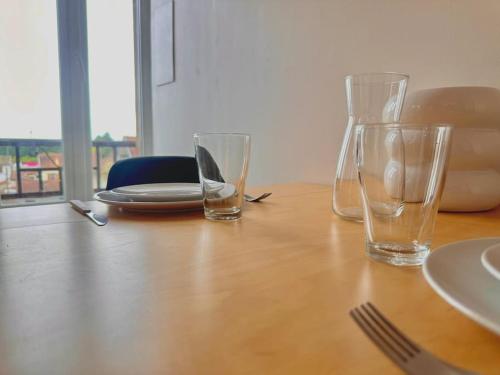 two empty glasses sitting on a wooden table at Le Néon Dijonnais in Dijon