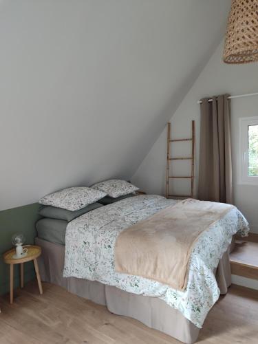 a bedroom with a bed and a ladder at Appartement Terrasse in Bagnoles de l'Orne