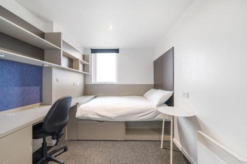 a small room with a bed and a desk and a computer at For Students Only Canvas City Point Coventry in Coventry
