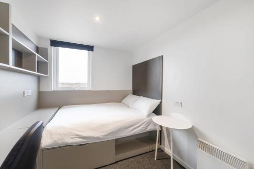 a small bedroom with a bed and a window at For Students Only Canvas City Point Coventry in Coventry