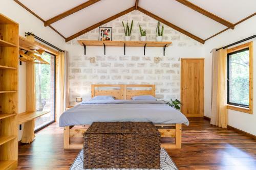 a bedroom with a bed with a wooden headboard at The Jungle Oasis with heated pool in Nairobi