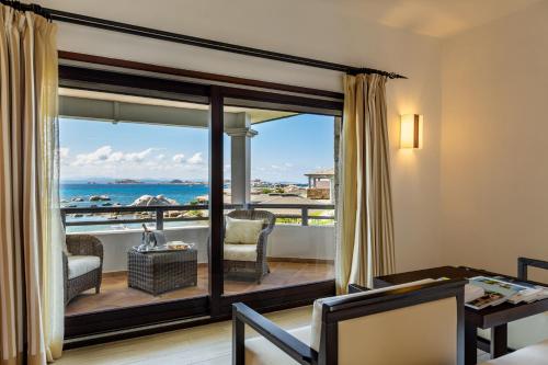 a living room with a view of the ocean at Hotel & SPA des Pecheurs in Bonifacio