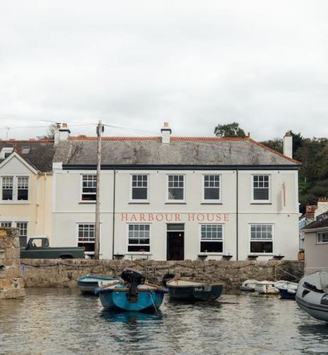 a large white building with boats in a body of water at no.five Flushing in Flushing