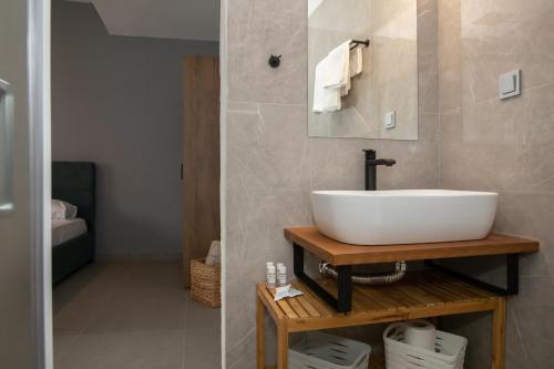 a bathroom with a white sink and a mirror at Suite of Liberty in Kos Town