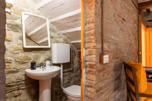La salle de bains en pierre est pourvue d'un lavabo et d'un miroir. dans l'établissement La Casa del Pescatore - Lake Trasimeno's Retreat, à San Feliciano