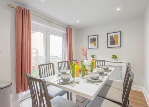 a white dining room with a white table and chairs at Modern House w/Terrace in Nottingham FREE Parking in Nottingham