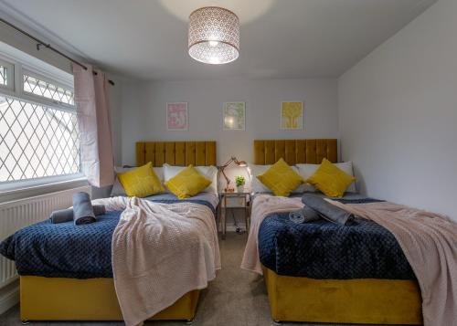 a bedroom with two beds and a table at Modern House w/Terrace in Nottingham FREE Parking in Nottingham
