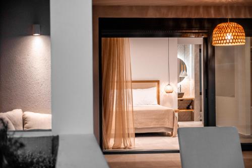 a bedroom with a bed and a mirror at Acacia - Explore your senses in Preveza