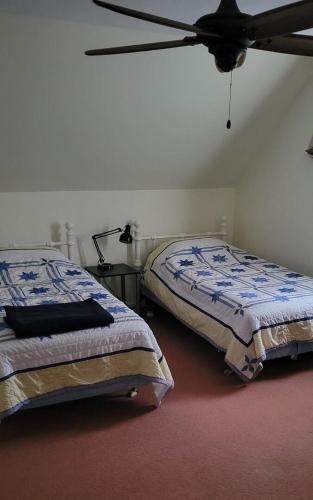 a bedroom with two beds and a ceiling fan at Family Retreat at York Beach Y609 Brought to you by GetAway Vacations in York