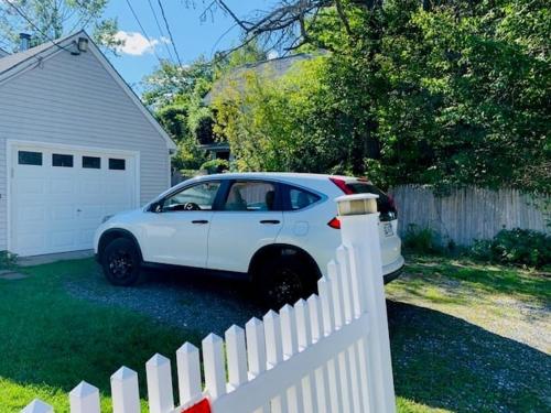 a white car parked next to a white fence at Family Retreat at York Beach Y609 home in York
