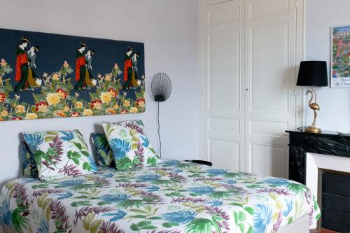 une chambre avec un lit et un tableau au mur dans l'établissement Villa Zachee - maison familiale & parking gratuit, au Tréport