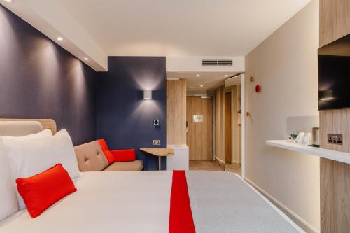 a hotel room with a bed and a living room at Holiday Inn Express Liverpool - Central by IHG in Liverpool