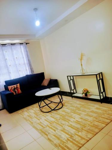a living room with a couch and a mirror at Cozy One bedroom B&B in Thika