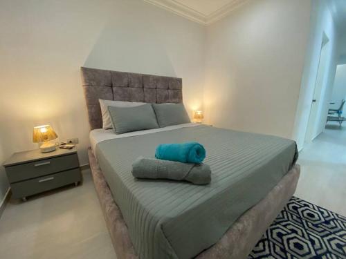 a bedroom with a bed with a blue pillow on it at Suite con acceso directo al Centro Comercial in Caracas