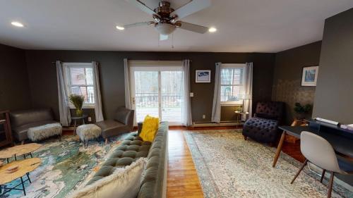 a living room with a couch and a table at Winter Lore Brought to you by GetAway Vacations in Mendon