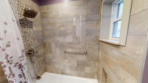 a bathroom with a shower with a toilet at Winter Lore Brought to you by GetAway Vacations in Mendon