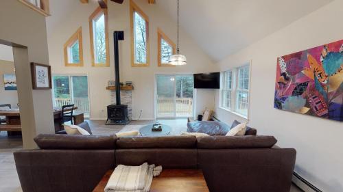 a living room with a couch and a table at The Mendon House home in Killington