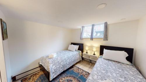 a bedroom with two beds and a window at Winter Lore Brought to you by GetAway Vacations in Mendon