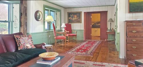 a living room with a couch and a table at Old Orchard House Brought to you by GetAway Vacations in Brandon