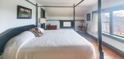 a bedroom with a large bed in a room at Old Orchard House Brought to you by GetAway Vacations in Brandon