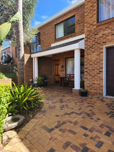 a brick house with a patio in front of it at Little Greece in Cape Town