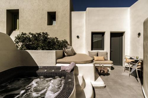 a patio with a hot tub on a table at Aeon Suites - Adults Only in Pirgos