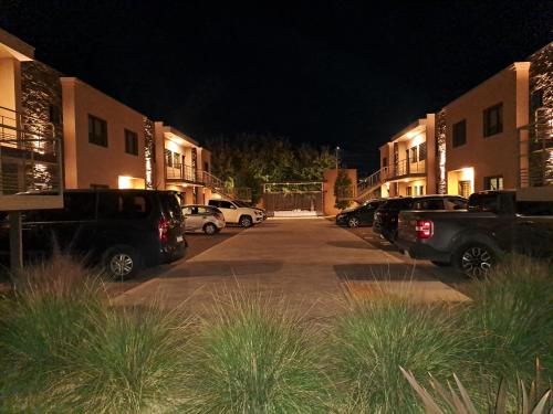 a parking lot with cars parked in front of buildings at UCO APARTS, tu refugio en el corazón de los Andes in Tupungato