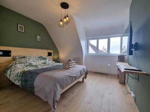 a bedroom with a bed and a large window at La Tanière de la baie - Maison 6-8 pers in Le Val-Saint-Père