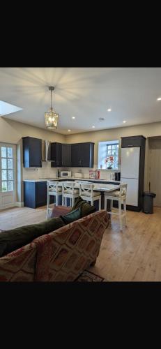 a living room with a table and a kitchen at Rokeby cottage in Drogheda