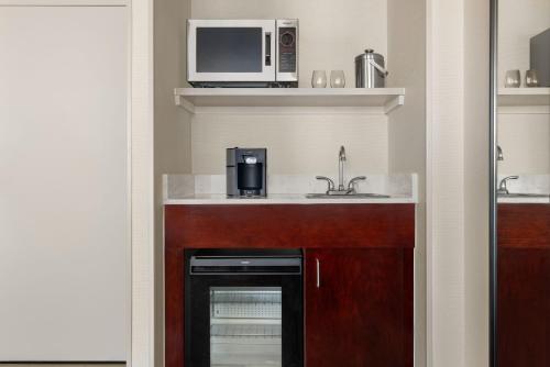 a kitchen with a sink and a microwave at Sheraton Suites Galleria Atlanta in Atlanta