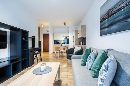 a living room with a couch and a table at Apartamenty Tespis - Francuska Atal Park in Katowice