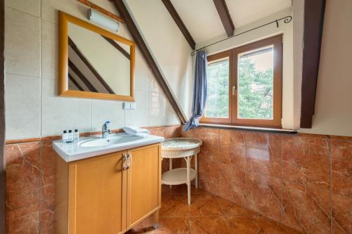 a bathroom with a sink and a window at Dom & House - Chata Rybaka in Sopot