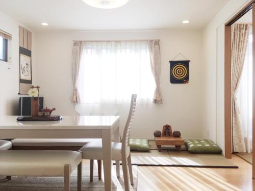a dining room with a table and chairs and a window at Tokyo Center Ikebukuro Family villa quiet 4BR group stay & parking near JR in Tokyo