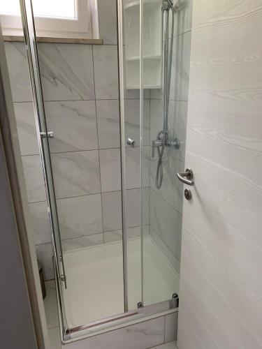 a shower with a glass door in a bathroom at Apartments and rooms with a swimming pool Pucisca, Brac - 5637 in Pučišća