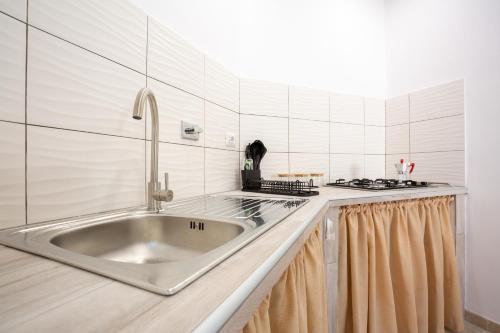 a kitchen with a sink and a stove at Tourist Apartment anna in Bracciano