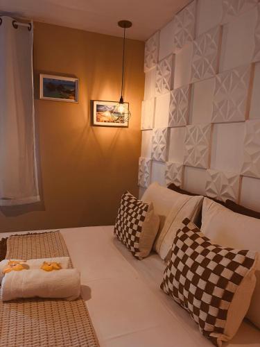 a room with a bed with pillows on it at Martinelli Residence in Fernando de Noronha