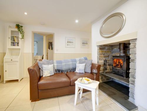 a living room with a couch and a fireplace at Bosuns Locker in Port Isaac