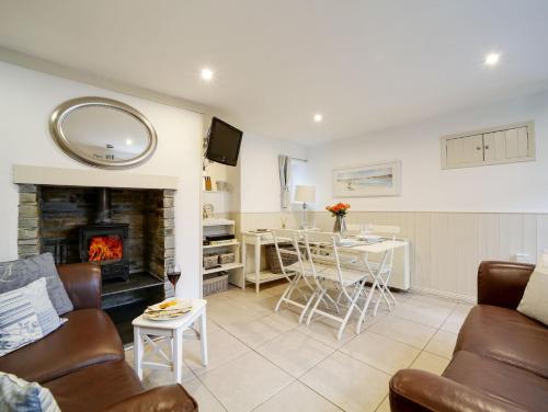 a living room with a couch and a fireplace at Bosuns Locker in Port Isaac