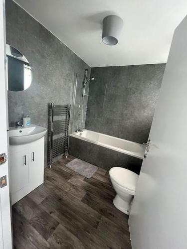 a bathroom with a toilet and a sink at The M Rooms at 144 in Kirk of Shotts