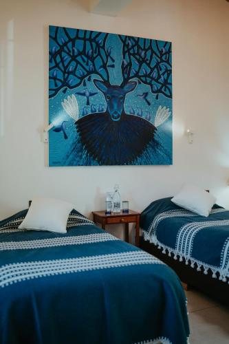 Postel nebo postele na pokoji v ubytování LARIMAR Gallery y Hotel Boutique