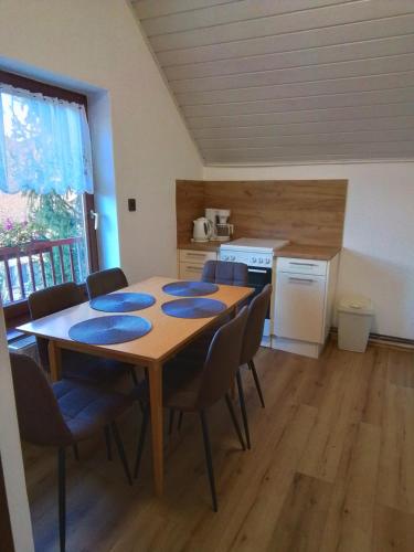 a room with a table and chairs and a kitchen at Villa Mariella in Siófok