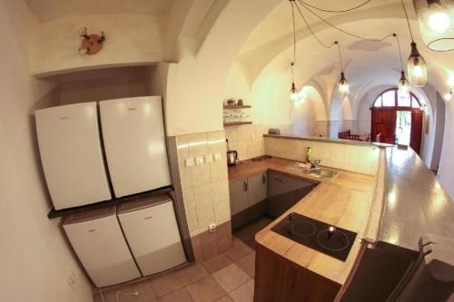 a kitchen with a sink and a refrigerator at Na Rynku in Český Krumlov