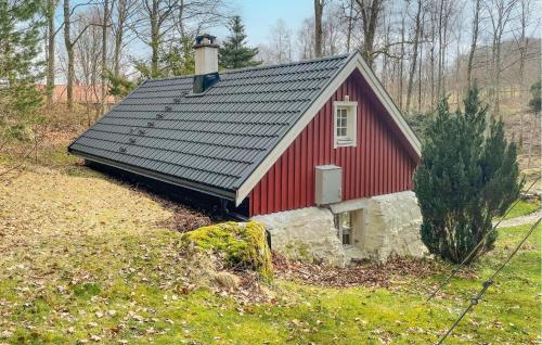 a red barn with a chimney on top of it at Amazing Home In Hässleholm With Wifi in Hässleholm