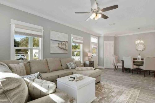 a living room with a couch and a ceiling fan at *Chic Beach Cottage Retreat* near Beach/downtown in Gulfport