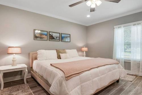 a bedroom with a bed and a ceiling fan at *Chic Beach Cottage Retreat* near Beach/downtown in Gulfport