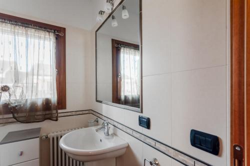 uma casa de banho com um lavatório e um espelho em Sweety Kalimera House with Private Parking&Garden! em Abano Terme