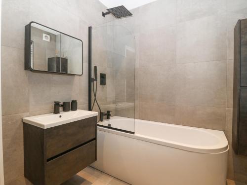 a bathroom with a toilet and a sink and a shower at Park View in Llandudno