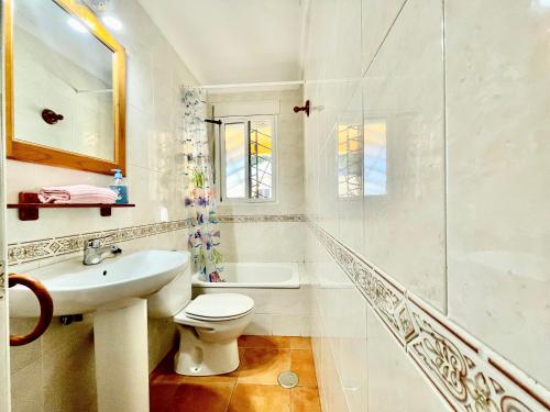 a bathroom with a sink and a toilet and a shower at Casa Boga - Urbasur in Islantilla