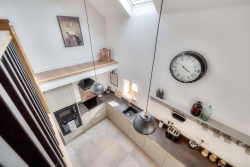 an overhead view of a kitchen with a clock on the wall at Tumbledown Barn in Knowstone